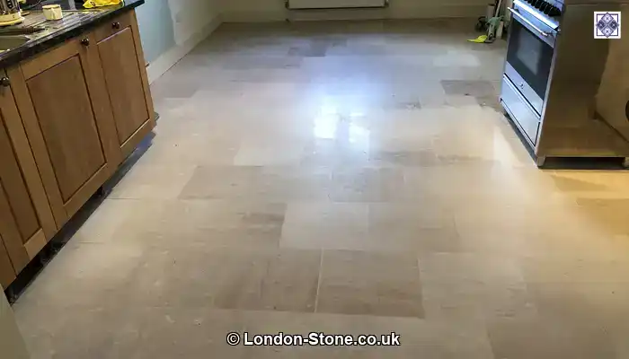 Impregnating sealer applied to pale limestone tiles, gently deepening the natural colour.